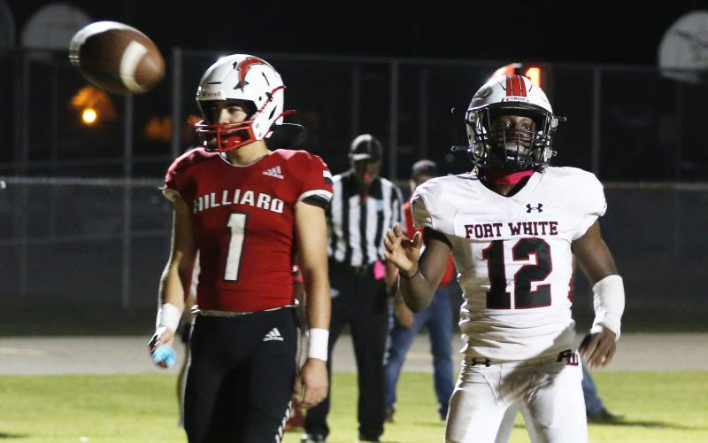 Fort White receiver Najeeb Smith flips the ball to the referee after scoring a touchdown against Hilliard last Friday. (MORGAN MCMULLEN/Lake City Reporter)