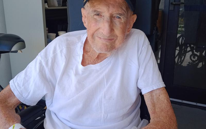 Ervin Seay Williams, who served in the U.S. Navy at Pearl Harbor during World War II, enjoys time with his plants at the Lake City VA Hospital. Williams turns 101 on Monday. (SEAN MCMAHON/Special to the Reporter)