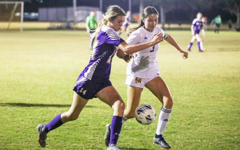 Columbia’s Mia Brasel fights for possession of the ball with Florida High’s Olivia Talevich on Friday. (BRENT KUYKENDALL/Lake City Reporter)
