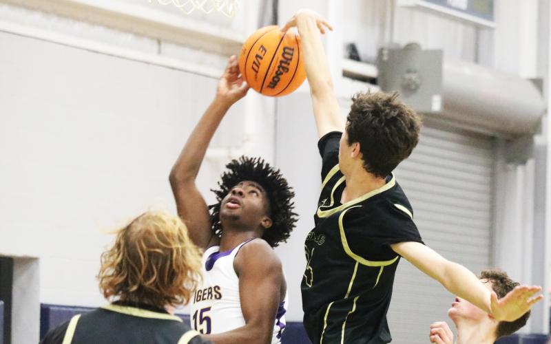Nease center Jack Sullivan (right) blocks Columbia forward Zavian Douglas’ shot during the Hitchcock’s Challenge on Wednesday. (JORDAN KROEGER/Lake City Reporter)