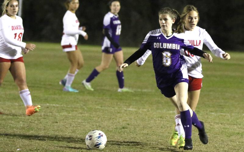 Columbia's Nikki Sossie dribbles past Wakulla's Brianna Stephens in the first half of Thursday's matchup. (MORGAN MCMULLEN/Lake City Reporter)