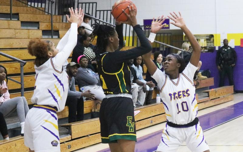 Columbia guards Mariah Cox (left) and Ayesha Broxey (right) trap Ed White center Leandrea McCloud in the backcourt on Wednesday. (JORDAN KROEGER/Lake City Reporter)