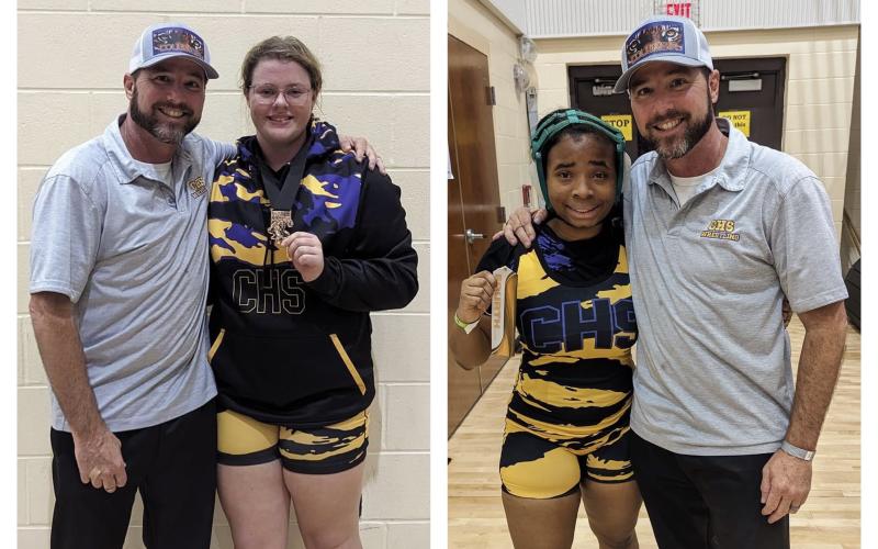 Columbia wrestlers Josie Raulerson (left) and Jay Jay Williams (right) are both pictured with head coach Pete Whittington after placing at the Lady Clash on Friday. (COURTESY)