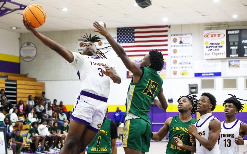 Columbia guard Zamarion Jones rises through the Suwannee defense for a layup on Nov. 28. (BRENT KUYKENDALL/Lake City Reporter)