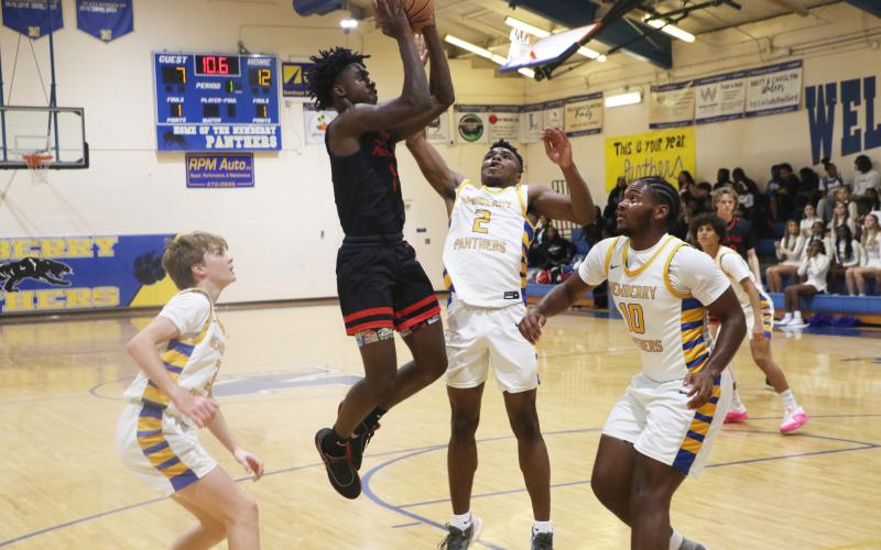 Fort White guard Jayden Jackson shoots over Newberry’s Kaleb Woods (2) and Logan McCloud (10) on Wednesday. (MORGAN MCMULLEN/Lake City Reporter)