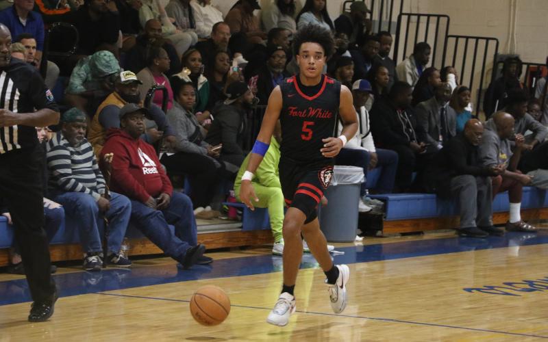 Fort White guard Tafari Moe dribbles down the court during a Dec. 6 game against Newberry. (FILE)