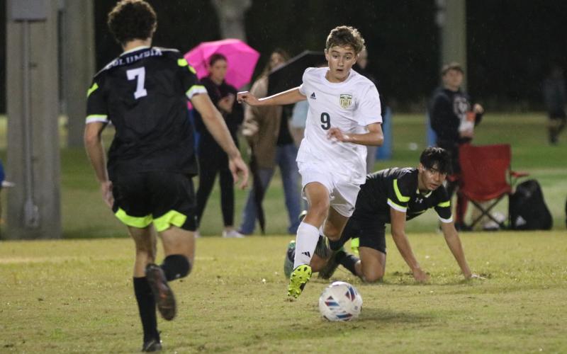 Lincoln’s Gavin Poucher dribbles past Columbia’s Diego Garcia on Friday. (JORDAN KROEGER/Lake City Reporter)