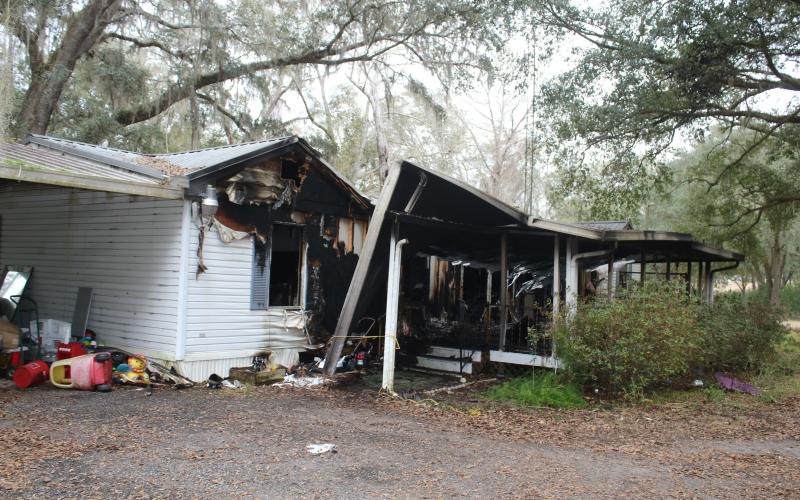 Columbia County firefighters pulled a woman and her two dogs from a mobile home fire on King Street on Tuesday morning. The woman was airlifted to an area hospital. (TONY BRITT/Lake City Reporter)