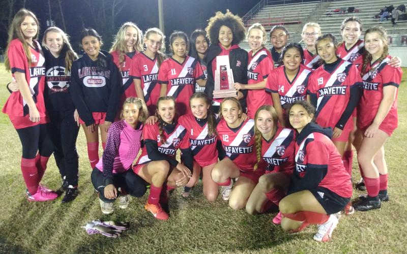 Lafayette's girls soccer team celebrates with the District 2-2A trophy after defeating Trenton on Tuesday night. (CONCEPCION LEDEZMA/Special to the Reporter)