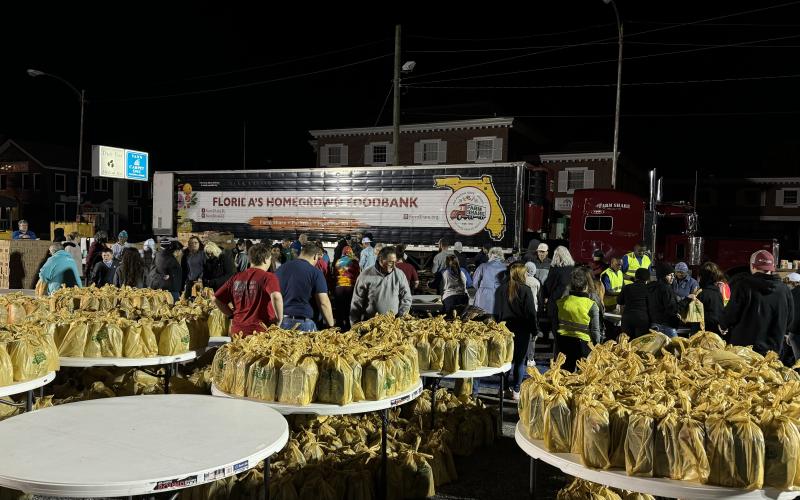 Volunteers help prepare an estimated 32,532 pounds of food early Saturday morning for the Farm Share distribution at the Lake City Police Department. (COURTESY LAKE CITY POLICE DEPARTMENT)