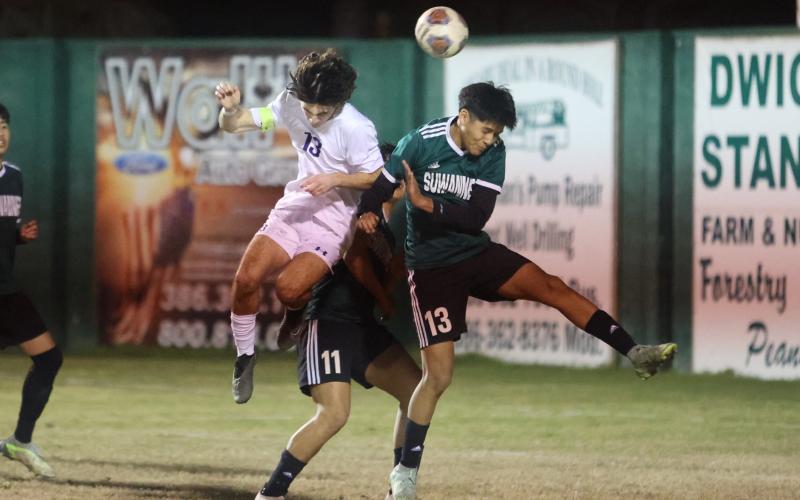 Columbia's Bergen Cobb and Suwannee's Angel Pena jump for a header during Monday night's match. (PAUL BUCHANAN/Special to the Reporter)