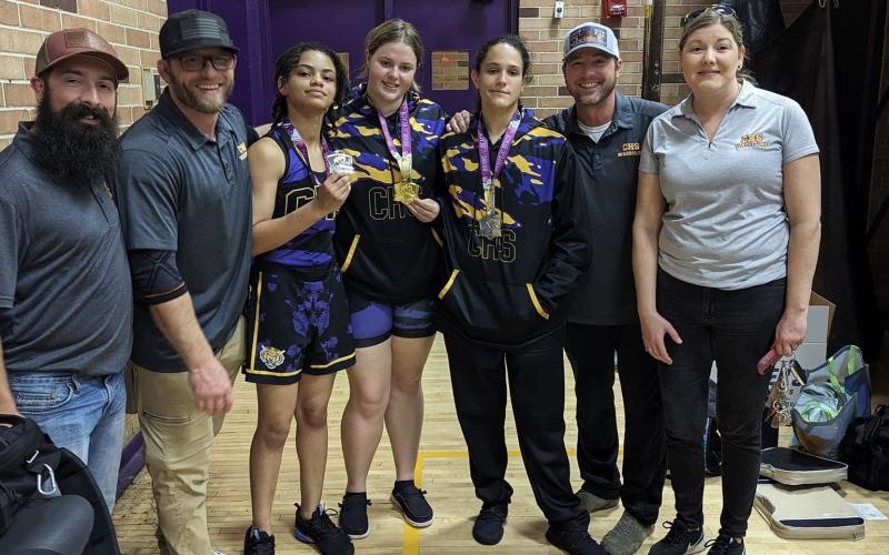Columbia wrestler Josie Raulerson (middle) won 235 class at the Fletcher Beach Brawl on Saturday, while Bella Guerrier-Lajoir (left of Raulerson) and Carlee Morrison (right of Raulerson) each placed second. (COURTESY)