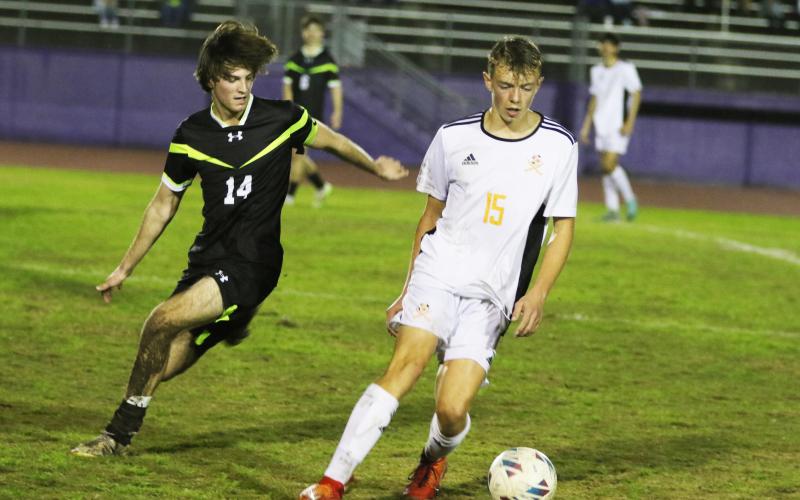 Columbia midfielder Bobby Shotwell (left) battles with Orange Park midfielder Andrew Gardiner for possession Friday night. (MORGAN MCMULLEN/Lake City Reporter))