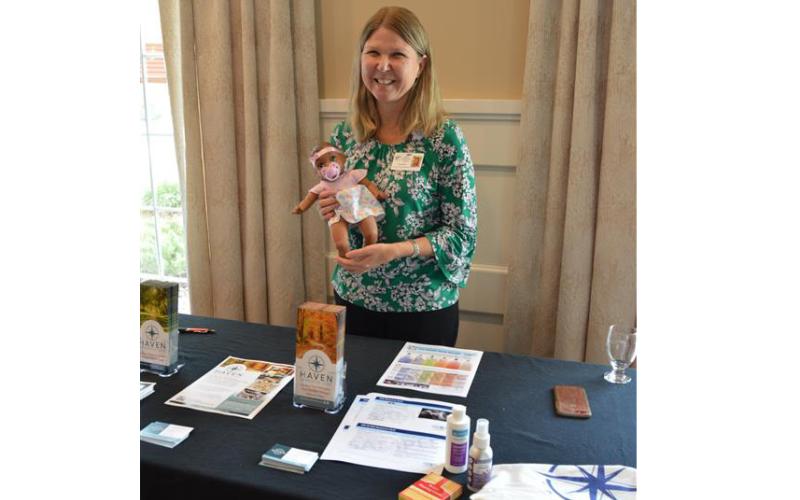Haven Hospice Dementia Care program manager Anita Howard displays some of the resources provided by the program, including enrichment tools and educational materials for caregivers. The Plein Foundation awarded Haven with a grant in support of the program. (COURTESY)