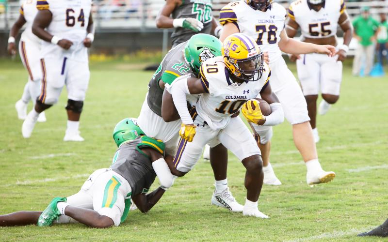 Columbia receiver Zamarion Jones tries to escape a tackle from Suwannee linebacker Lan’darren Gross during last season’s Preseason Classic. The teams will meet in the season opener this year on Aug. 23. (BRENT KUYKENDALL/Lake City Reporter)