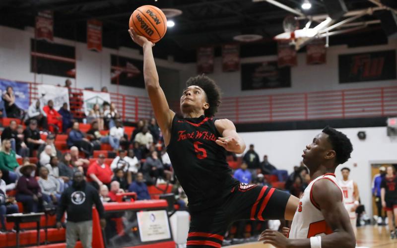 Fort White guard Tafari Moe rises for a shot while defended by Hawthorne guard CJ Ingram during the District 6-1A semifinals on Feb. 8. (BRENT KUYKENDALL/Lake City Reporter)