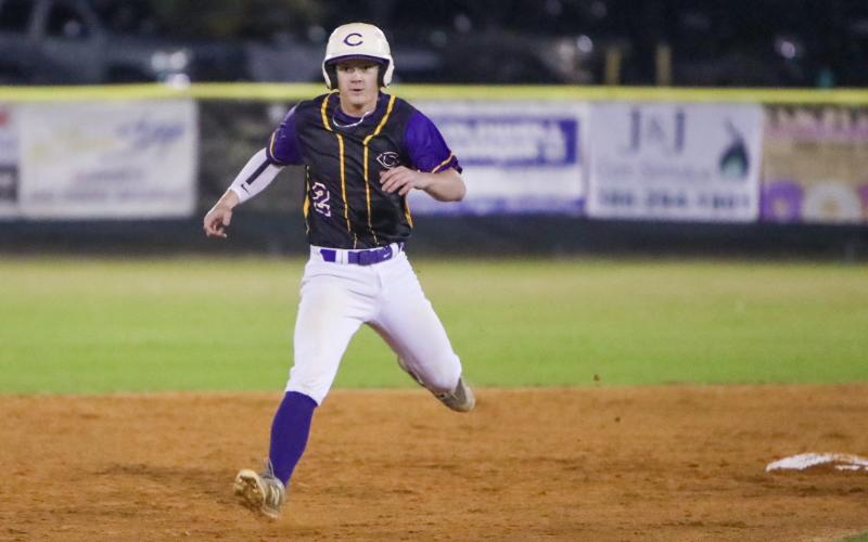Columbia outfielder Branson Mann turns off second base toward third during Tuesday's season opener against North Marion. (BRENT KUYKENDALL/Lake City Reporter)