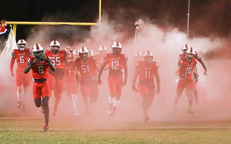 Fort White quarterback Jayden Jackson leads his team on to the field prior to the Region 3-1A semifinal against Union County last season. (BRENT KUYKENDALL/Lake City Reporter)