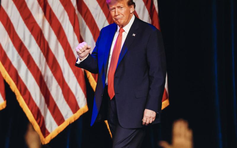 Former President Donald Trump pumps his fist as he enters to speak at a caucus night watch party at Treasure Island on Thursday in Las Vegas. (Madeline Carter/Las Vegas Review-Journal/TNS)