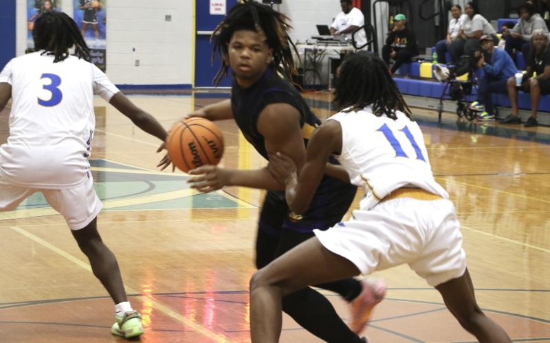 Columbia forward Jalen Gaskins looks for a lane to the basket while being defended by Rickards forward Travell Gallon during Saturday's District 2-5A championship. (MORGAN MCMULLEN/Lake City Reporter)
