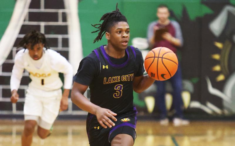 Columbia guard Zamarion Jones dribbles up the court against Suwannee on Tuesday night. (PAUL BUCHANAN/Special to the Reporter)