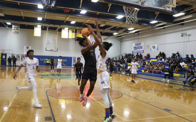Columbia forward Justice Kelly has his shot blocked by Rickards' Travis Morris in the second half of Saturday's District 2-5A championship. (MORGAN MCMULLEN/Lake City Reporter)