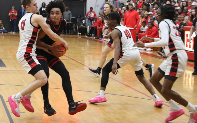 Fort White guard Tafari Moe gets tied up with Hilliard’s Brandyn Seldomridge in the fourth quarter of Tuesday’s Region 3-1A championship. (MORGAN MCMULLEN/Lake City Reporter)