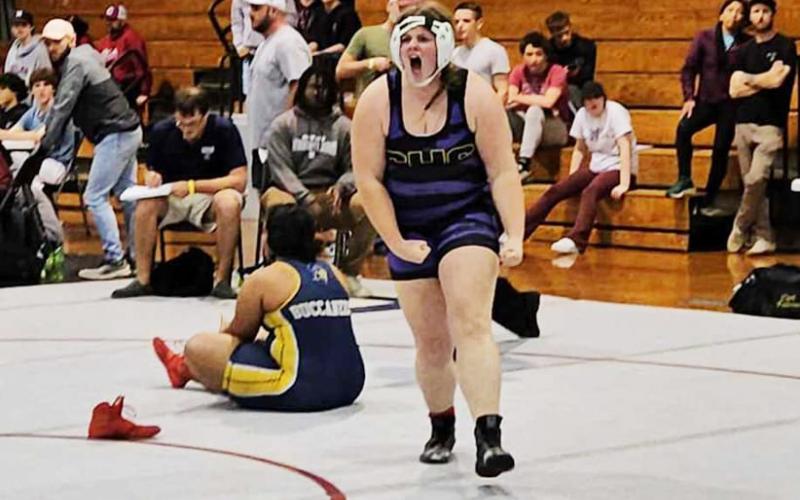 Columbia wrestler Josie Raulerson celebrates after pinning Mainland wrestler Cheyenne Wigley to win the Region 1-1A championship in the 235-pound weight class. (COURTESY)