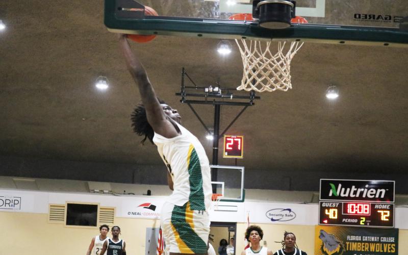 FGC forward Ty'jahn Wright rises to the basket for a dunk against Thomas University JV on Thursday night. (JORDAN KROEGER/Lake City Reporter)