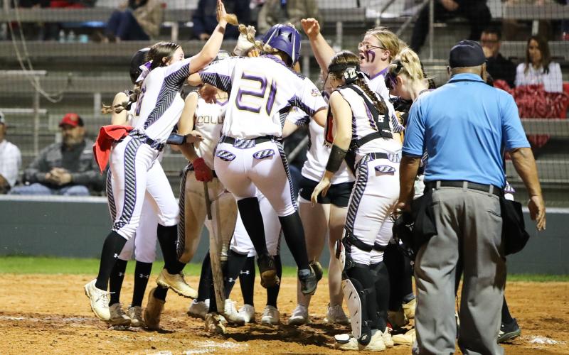 Columbia's Harleigh Price (21) is greeted at home plate after hitting a go-ahead 3-run home run against Lafayette on Thursday night. (JORDAN KROEGER/Lake City Reporter)