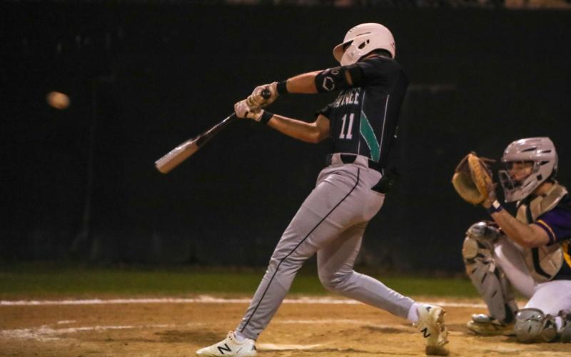 Suwannee’s Logan Brooks makes contact with a pitch against Columbia on Feb. 29. (BRENT KUYKENDALL/Lake City Reporter)