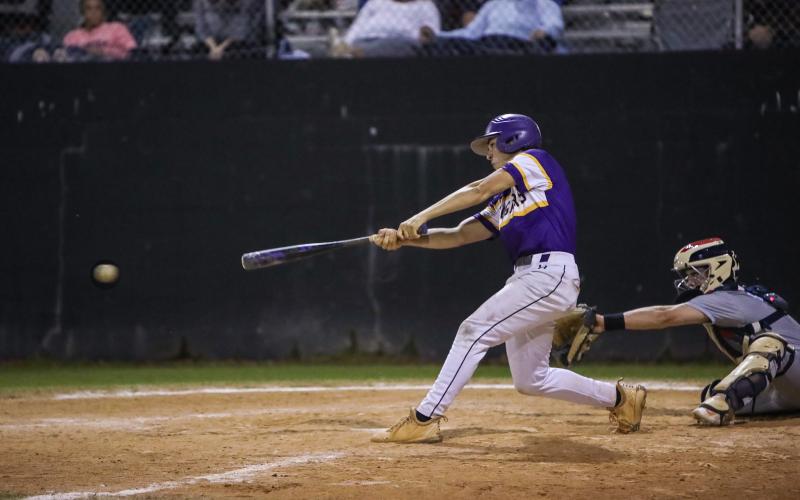 Columbia’s Grant Bowers makes contact with a pitch against St. Johns Country Day on March 1. (BRENT KUYKENDALL/Lake City Reporter)