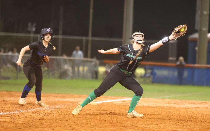 Suwannee third baseman Haley Law makes a catch as Branford outfielder Ashlee Combee looks on at third base on March 6. (PAUL BUCHANAN/Special to the Reporter)