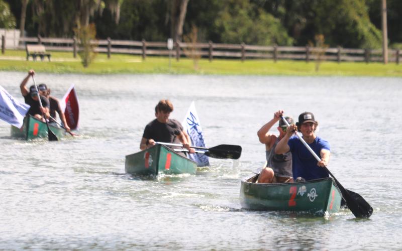 Brock and William Dees, the winners of the inaugural DeSoto Derby Canoe Race, lead down the home stretch of their heat during Saturday’s fundraising event for Lake City Elks Lodge #893. (TONY BRITT/Lake City Reporter)