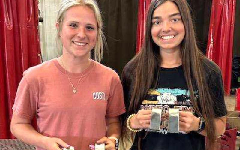 CHS welders Karsyn Sims (left) and Madison Bailey became the first female students at CHS to earn their welding certificates after passing their tests Tuesday. (COURTESY)