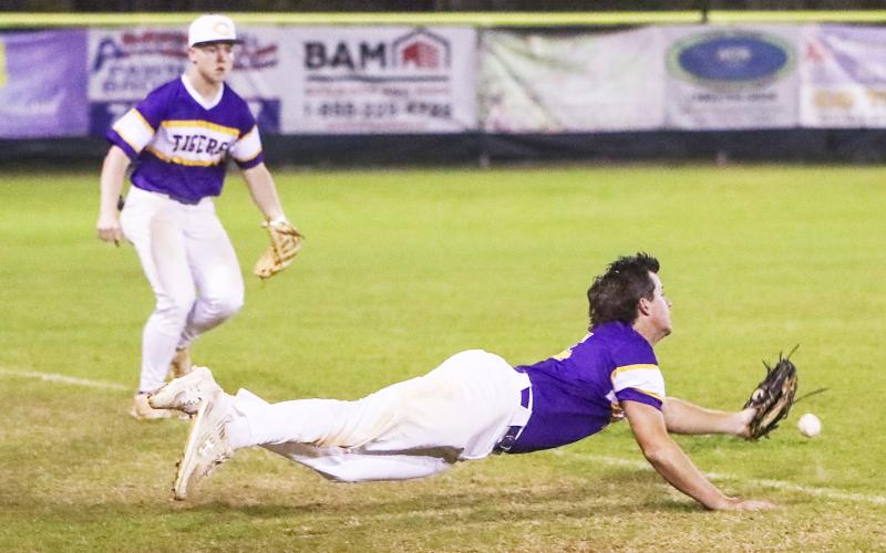 Columbia third baseman Brett Jones can’t track down a pop up that lands just inside the foul line during Friday’s game against St. Johns Country Day. (BRENT KUYKENDALL/Lake City Reporter)