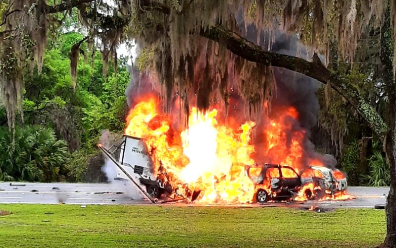 Two SUVs and a travel trailer burst into flames Friday evening on State Road 136 near the State Farmer’s Market in White Springs. A Lake City man was killed in the crash. (GLENN ALLEN/Special to the Reporter)