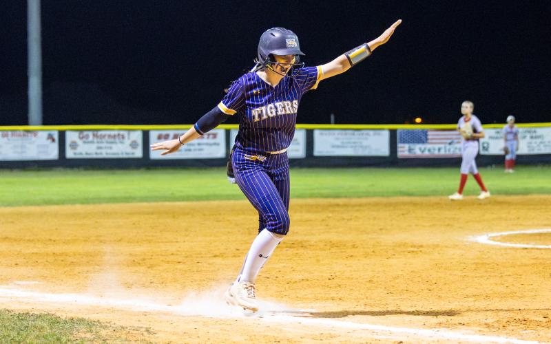 Columbia catcher Emily Delgado dances down the third base line as he head to ward home plate after hitting a 2-run home run during the Tigers’ 13-run fifth inning against Lafayette on Tuesday. (JACK HOWDESHELL/Special to the Reporter)