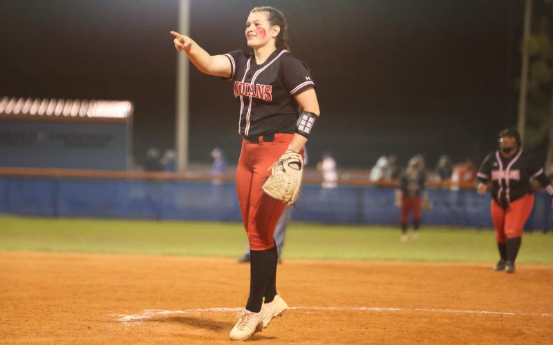 Fort White pitcher Kadence Compton celebrates after a strikeout against Branford on March 1. (PAUL BUCHANAN/Special to the Reporter)