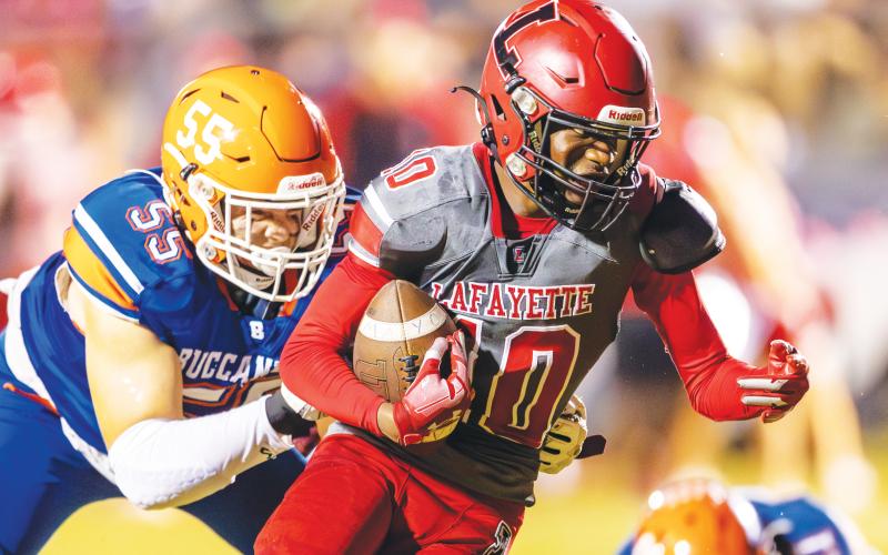 Lafayette receiver Jordan Murphy tries to escape a tackle from Branford defensive lineman Tate Dampier last Friday. (FILE)