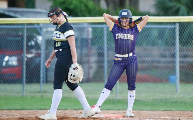 Columbia shortstop Lillyenne Mayhew smiles at first base after reaching on a single against Buchholz on Thursday. (BRENT KUYKENDALL/Lake City Reporter)