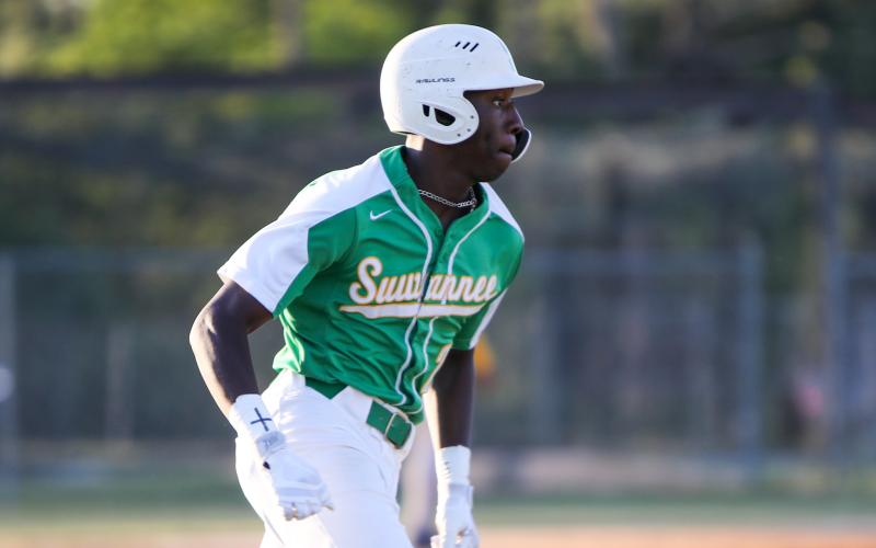 Suwannee right fielder PJ Davis races to first base after a hit against Rickards on Tuesday. (BRENT KUYKENDALL/Lake City Reporter)