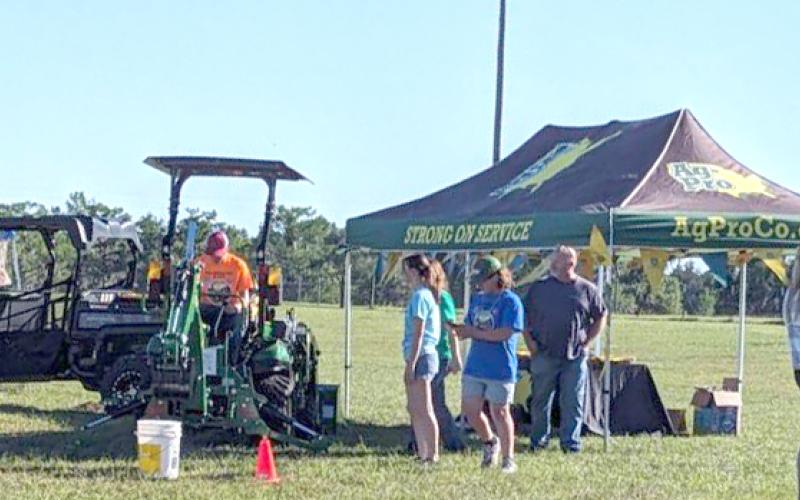 Kids Feeding Kids Ag Expo participants line up for a turn on some farm equipment during last weekend’s event. (COURTESY)