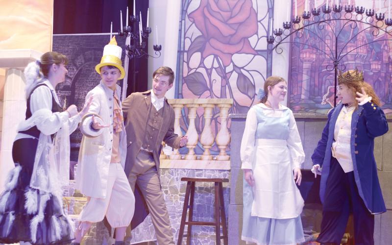 Fort White High School thespians Gracie Norman (from left), Mason Steele, Casey Dettman, Gracey Ayers and Juliette Torres, rehearse a scene for the school’s upcoming production of Beauty and The Beast. The production is the first musical in the school’s history and the first production in the school’s new performing arts center. (TONY BRITT/Lake City Reporter)