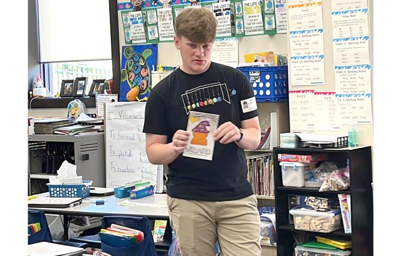 Jacob Sheldon reads his book, ‘I Think My Cat’s A Wizard’ to students at Belmont Academy. (COURTESY)