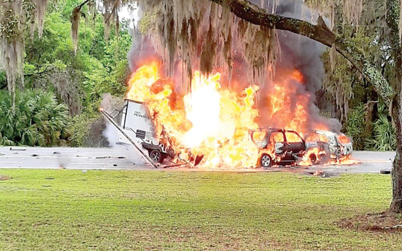 Two SUVs and a camper are engulfed in flames after a crash on State Road 136 near the State Farmer’s Market in White Springs on March 22. (COURTESY OF GLENN ALLEN)