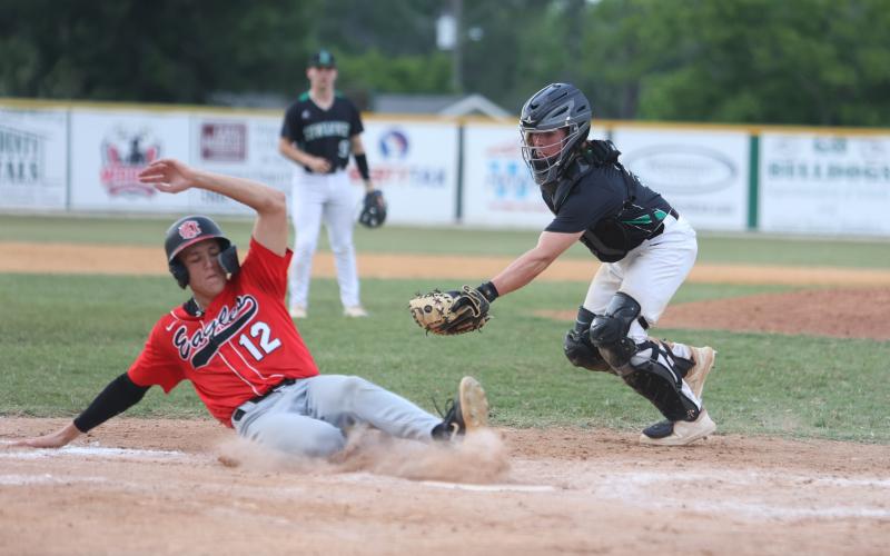 NFC's Jace Riggan slides safely into home plate ahead of a tag from Suwannee catcher Grayson Bonds on Thursday. (PAUL BUCHANAN/Special to the Reporter)