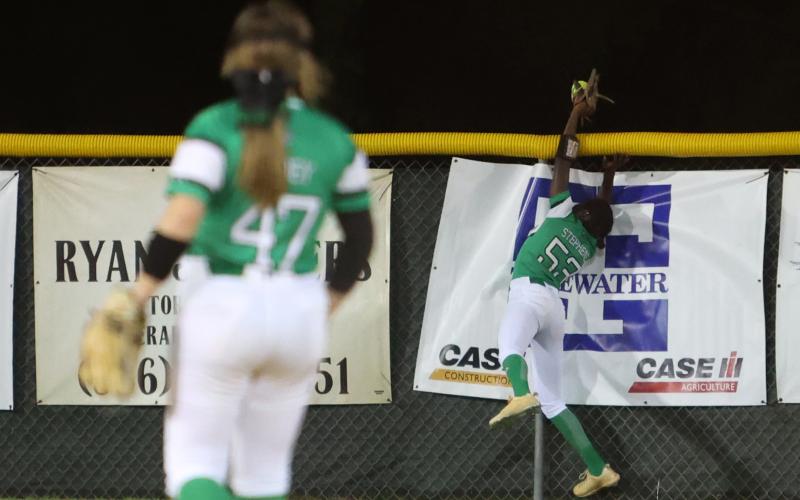 Suwannee center fielder Brianna Stephens can’t reach a Gainesville home run as it flies over the fence on Friday. (PAUL BUCHANAN/Special to the Reporter)