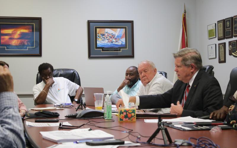 Robert Jones (from left), CareerSource Florida Crown Executive Director, Ron Jones, and Eugene Dukes, board chairman, listen intently as Guy Norris, Florida Crown legal counsel, talks about recent economic sanctions applied to the agency during the Wednesday morning’s CareerSource Florida Crown board meeting. (TONY BRITT/Lake City Reporter)