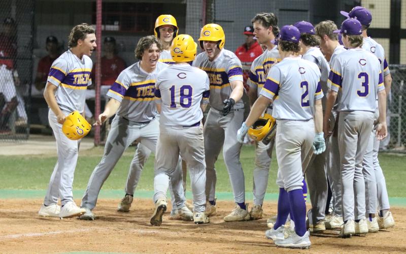 Columbia catcher Casen Maddox is greeted at home plate after hitting a go-ahead grand slam against Santa Fe on Tuesday. His home run put the Tigers up 6-5 and was part of an eight-run six inning. (JORDAN KROEGER/Lake City Reporter)